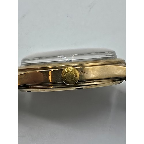 28 - A 9ct gold cased Baume Gents wristwatch. 25mm champagne face with Arabic markers and subsidiary seco... 
