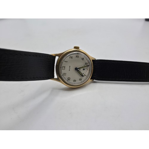 28 - A 9ct gold cased Baume Gents wristwatch. 25mm champagne face with Arabic markers and subsidiary seco... 