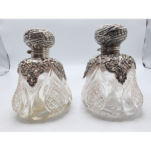 15 - A pair of sterling silver mounted glass scent bottles by Henry Matthews Birmingham, 1898, one with m... 