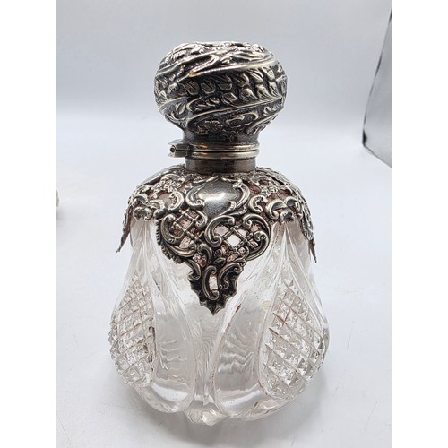 15 - A pair of sterling silver mounted glass scent bottles by Henry Matthews Birmingham, 1898, one with m... 