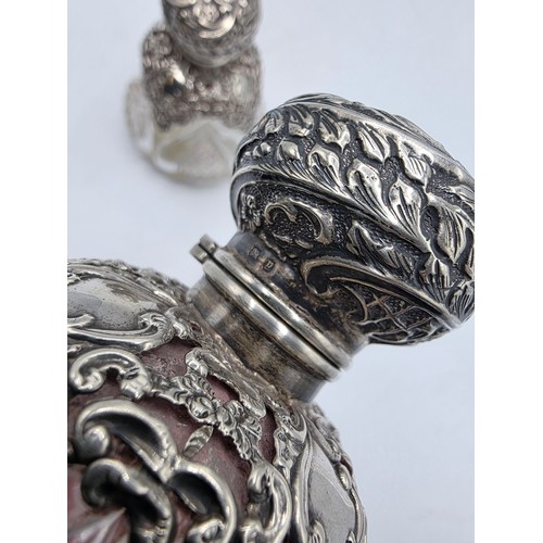 15 - A pair of sterling silver mounted glass scent bottles by Henry Matthews Birmingham, 1898, one with m... 