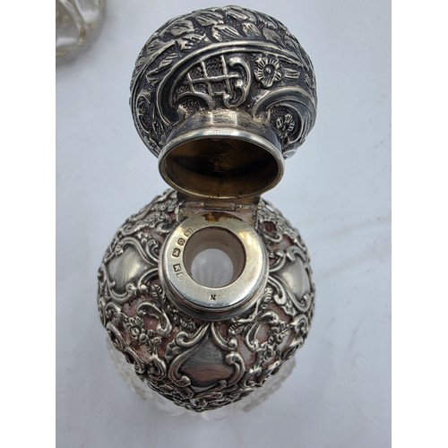 15 - A pair of sterling silver mounted glass scent bottles by Henry Matthews Birmingham, 1898, one with m... 