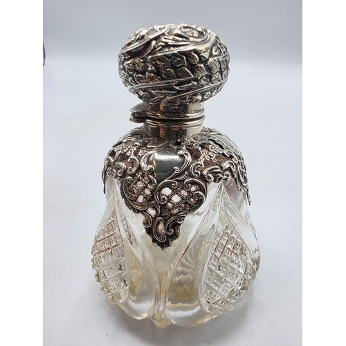 15 - A pair of sterling silver mounted glass scent bottles by Henry Matthews Birmingham, 1898, one with m... 
