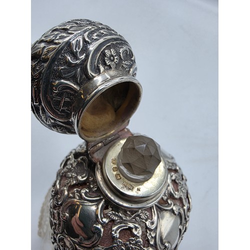 15 - A pair of sterling silver mounted glass scent bottles by Henry Matthews Birmingham, 1898, one with m... 