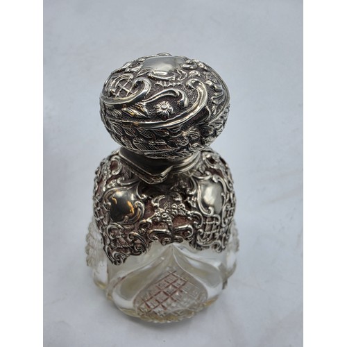 15 - A pair of sterling silver mounted glass scent bottles by Henry Matthews Birmingham, 1898, one with m... 