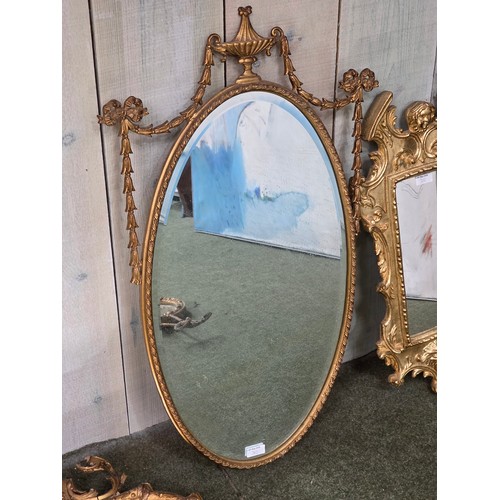 310 - Four decorative gilt wall mirrors