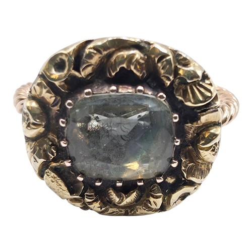 88 - An early 19th Century style unmarked yellow metal and pale green beryl ladies ring with cast floral ... 