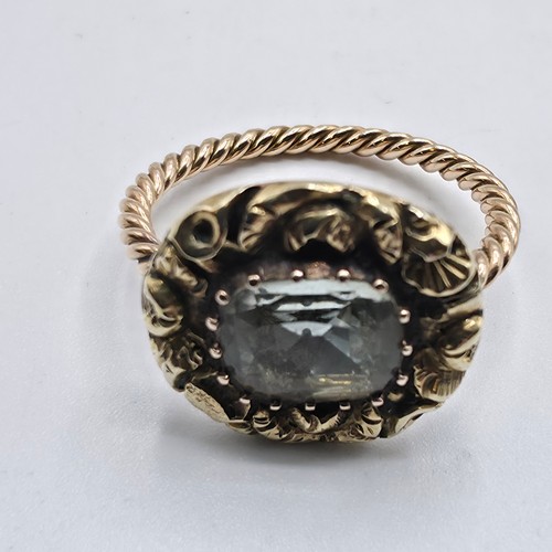 88 - An early 19th Century style unmarked yellow metal and pale green beryl ladies ring with cast floral ... 