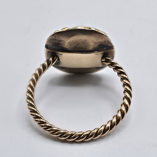 88 - An early 19th Century style unmarked yellow metal and pale green beryl ladies ring with cast floral ... 