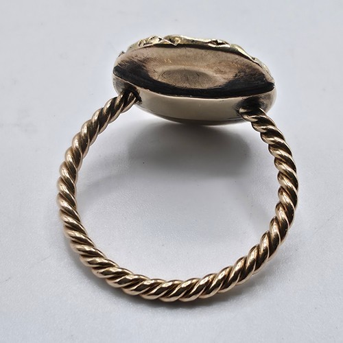 88 - An early 19th Century style unmarked yellow metal and pale green beryl ladies ring with cast floral ... 