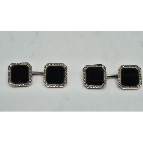 91 - A pair of platinum black onyx and single cut diamond double sided octagonal shaped cufflinks togethe... 