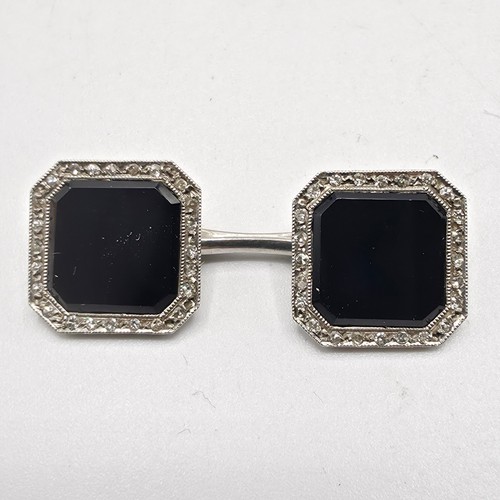 91 - A pair of platinum black onyx and single cut diamond double sided octagonal shaped cufflinks togethe... 