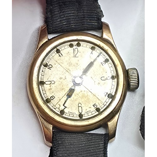 92 - A 9ct gold cased wrist watch 20 mm face with Arabic markers on a fabric strap, gross weight 13 g