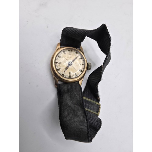 92 - A 9ct gold cased wrist watch 20 mm face with Arabic markers on a fabric strap, gross weight 13 g