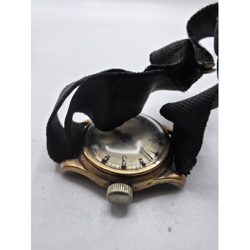 92 - A 9ct gold cased wrist watch 20 mm face with Arabic markers on a fabric strap, gross weight 13 g