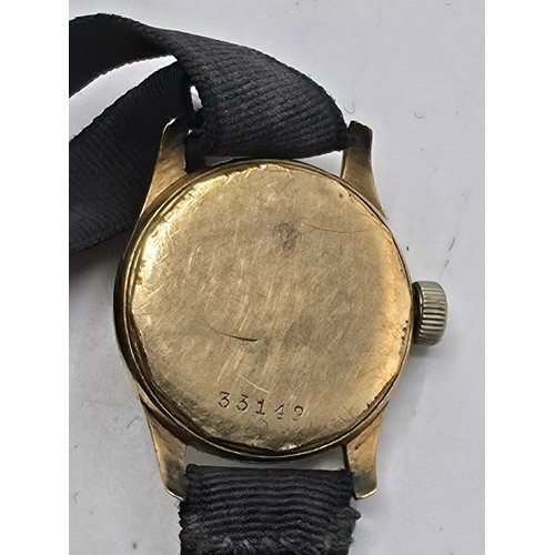 92 - A 9ct gold cased wrist watch 20 mm face with Arabic markers on a fabric strap, gross weight 13 g