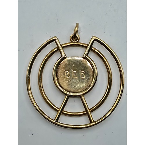 93 - A 9ct gold open work pendant with central circular engraved plate 