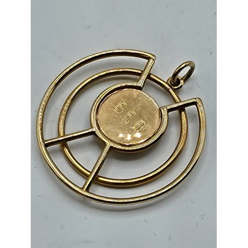 93 - A 9ct gold open work pendant with central circular engraved plate 