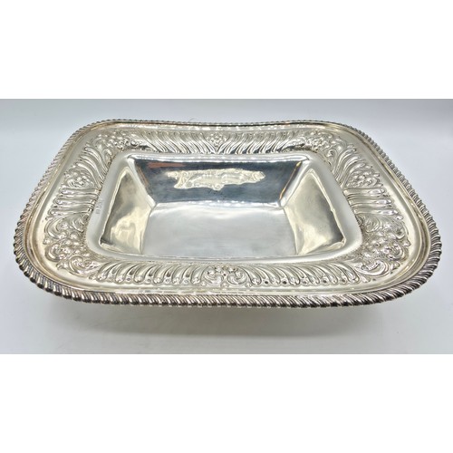 118 - A sterling silver serving dish with repousse decoration and beaded rim by Henry Atkin Sheffield 1894... 