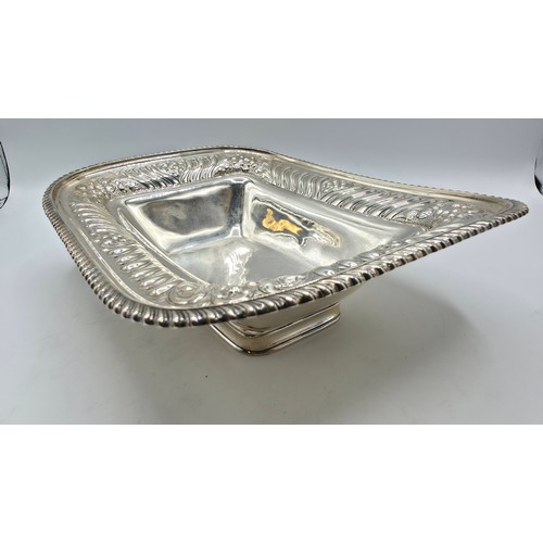 118 - A sterling silver serving dish with repousse decoration and beaded rim by Henry Atkin Sheffield 1894... 