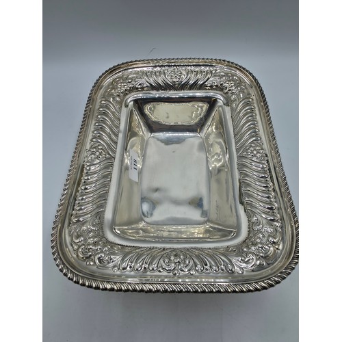 118 - A sterling silver serving dish with repousse decoration and beaded rim by Henry Atkin Sheffield 1894... 