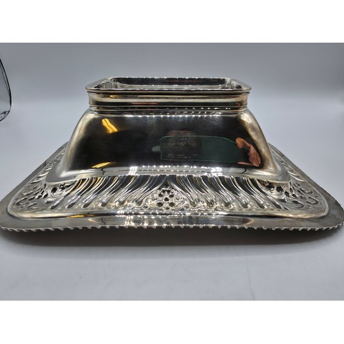 118 - A sterling silver serving dish with repousse decoration and beaded rim by Henry Atkin Sheffield 1894... 