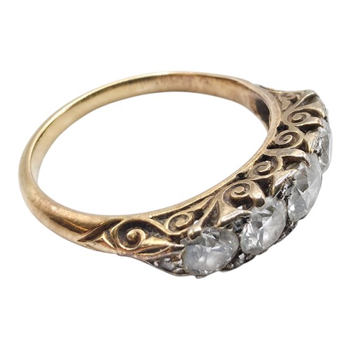 106 - An unmarked yellow metal diamond five stone ring. Line of graduated brilliant cut diamonds with rose... 