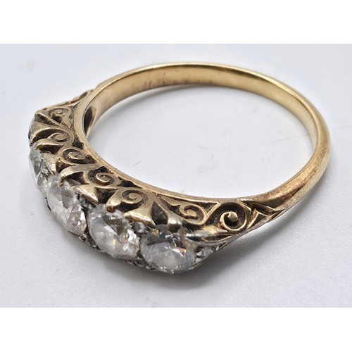 106 - An unmarked yellow metal diamond five stone ring. Line of graduated brilliant cut diamonds with rose... 