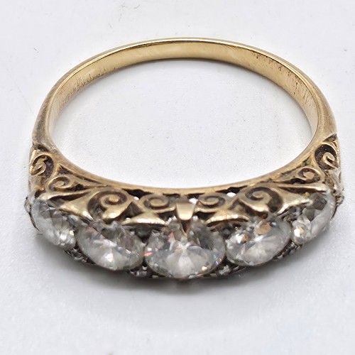 106 - An unmarked yellow metal diamond five stone ring. Line of graduated brilliant cut diamonds with rose... 