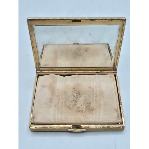 110 - Cartier. A 9ct gold case ladies compact, Marked to interior JC, London, mirrored interior. 8cm x 6cm... 