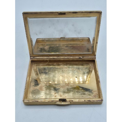 110 - Cartier. A 9ct gold case ladies compact, Marked to interior JC, London, mirrored interior. 8cm x 6cm... 