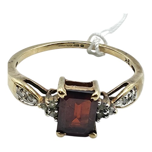 25 - A 9ct gold and garnet set ring with single cut diamond set shoulders. Size P. 2g.