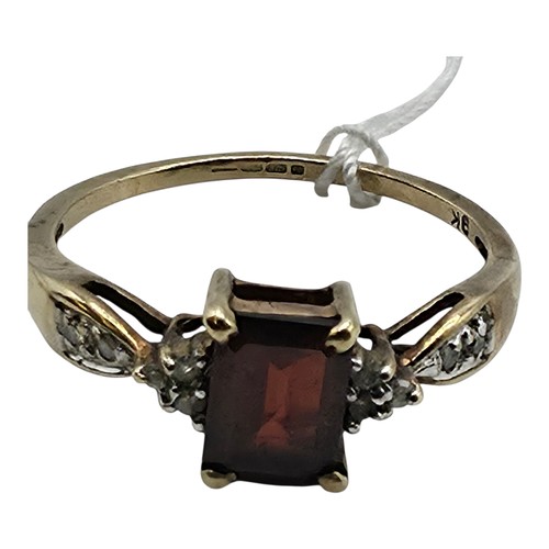 25 - A 9ct gold and garnet set ring with single cut diamond set shoulders. Size P. 2g.