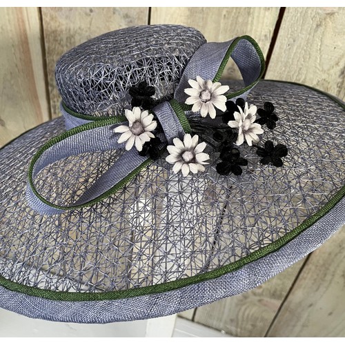 266 - A bespoke Rachel Trevor Morgan, London, sky blue fine mesh straw hat, with green flower and daisy tr... 