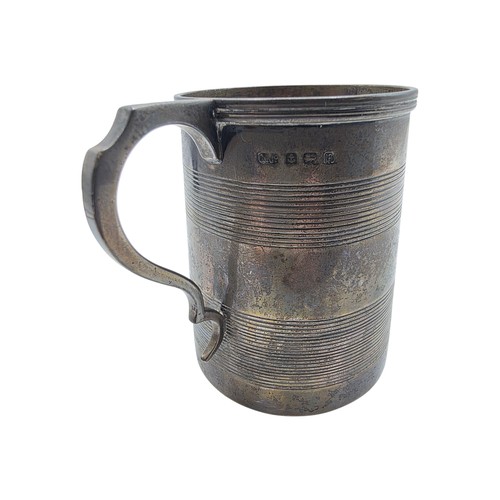 36 - Three sterling silver items , a mug, a christening cup and a pair of wishbone sugar tongs , various ... 