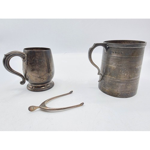 36 - Three sterling silver items , a mug, a christening cup and a pair of wishbone sugar tongs , various ... 