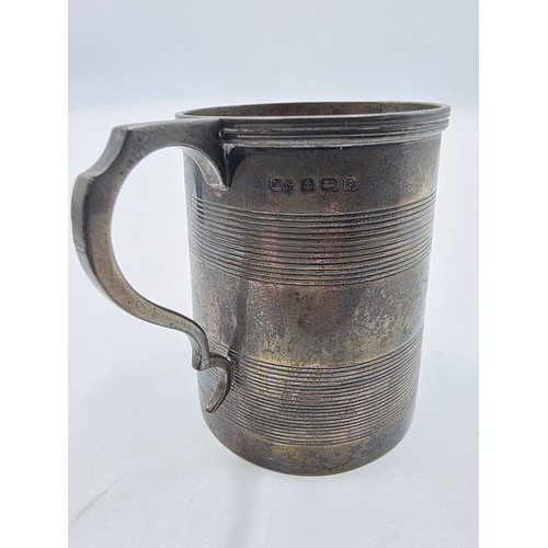 36 - Three sterling silver items , a mug, a christening cup and a pair of wishbone sugar tongs , various ... 