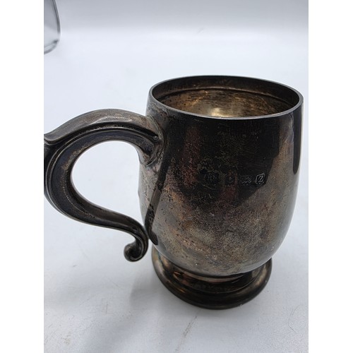 36 - Three sterling silver items , a mug, a christening cup and a pair of wishbone sugar tongs , various ... 