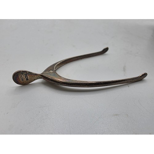 36 - Three sterling silver items , a mug, a christening cup and a pair of wishbone sugar tongs , various ... 