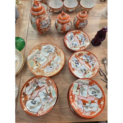 476 - A Japanese egg shell porcelain tea set and commemorative mugs.