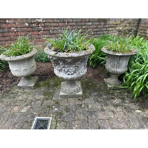 498 - Three Campagna stoneware garden urns, one larger example all on square bases. Largest 72cm(h)