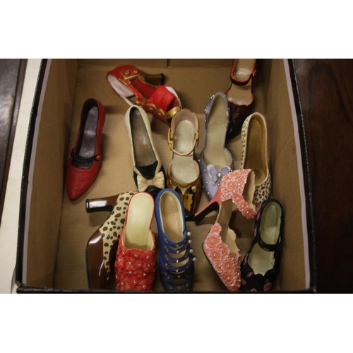 209 - BOX OF DECORATIVE CERAMIC SHOES (12)