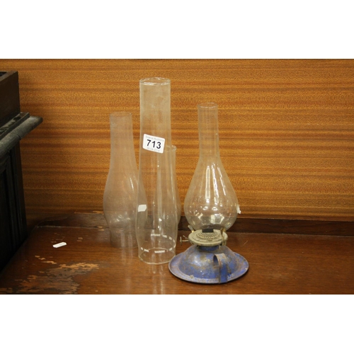 713 - 4 LAMP CHIMNEYS & OIL LAMP BASE