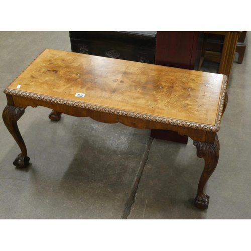 569 - HEAVILY CARVED QUARTERED WALNUT COFFEE TABLE