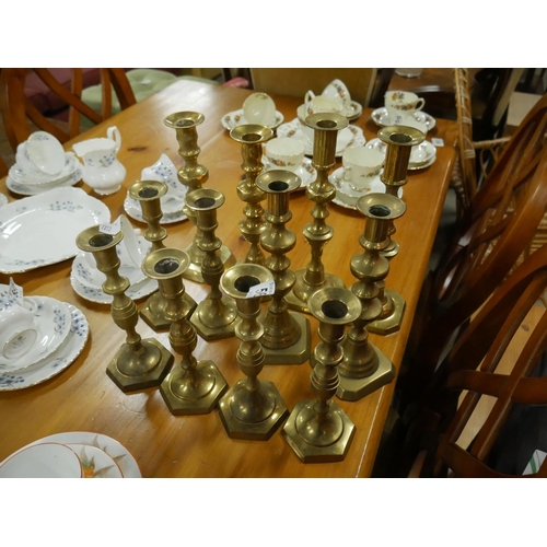 560 - LARGE LOT OF BRASS CANDLESTICKS