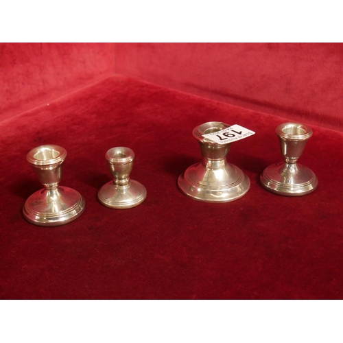 197 - 4 SMALL SILVER CANDLESTICKS