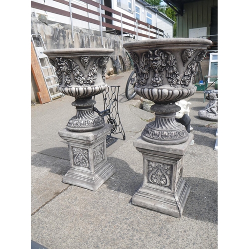 172 - PAIR OF CONCRETE URNS ON PLINTHS