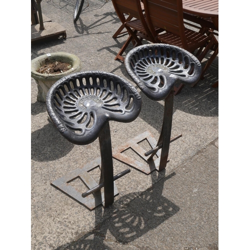 194 - 2 CAST IRON REAPER SEAT STOOLS