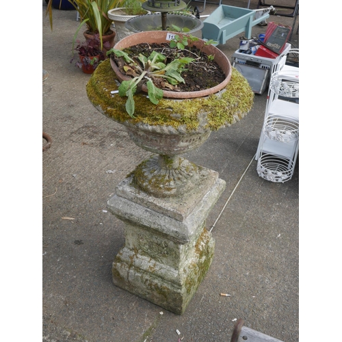 113 - AGED CONCRETE URN ON PLINTH - URN HAS AN OLD CRACK BUT IS STABLE