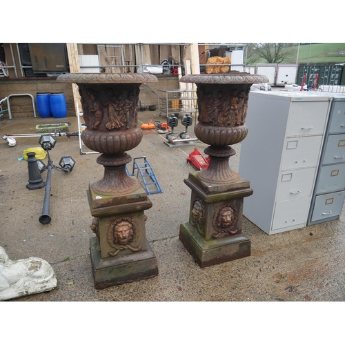 77 - PAIR OF DECORATIVE CAST IRON PLANTERS ON PLINTHS APPROX 5ft HIGH - SLIGHT DAMAGE AS SHOWN